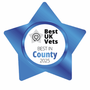 A blue, star-shaped badge with the words Best UK Vets, Best in County 2025 in the middle.