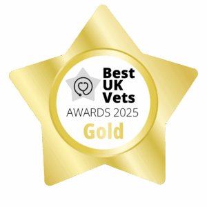 A gold, star-shaped badge with the words Best UK Vets Awards 2025 Gold. There is a heart and a stethoscope picture in the middle.