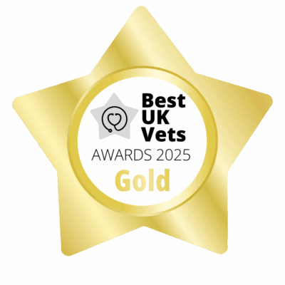 A gold, star-shaped badge with the words Best UK Vets Awards 2025 Gold. There is a heart and a stethoscope picture in the middle.