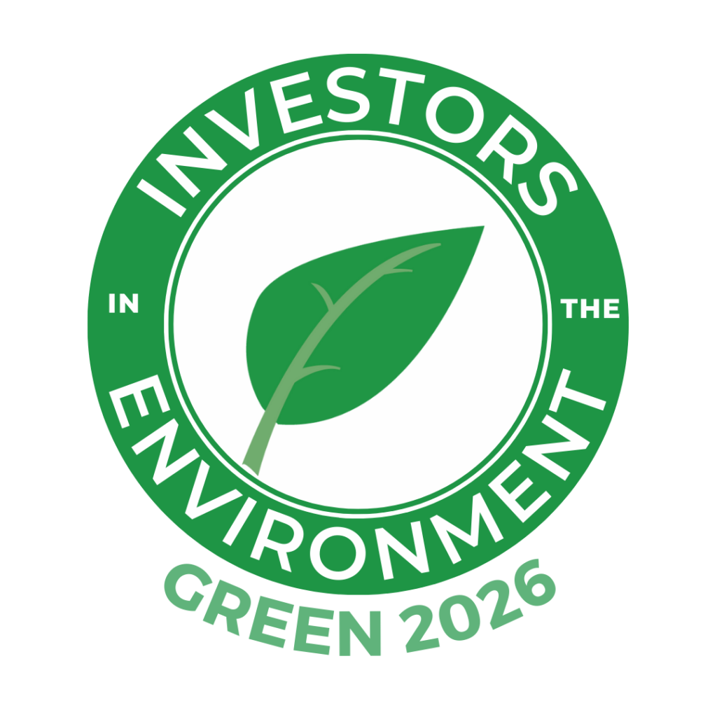 A round green logo with a leaf in the middle. The words say Investors in the Environment Green 2026.